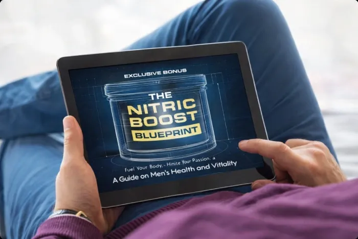 Person holding tablet displaying The Nitric Boost Blueprint bonus guide
